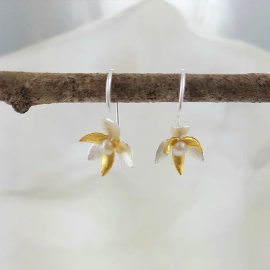 Gold and silver orchids with tiny pearl centres